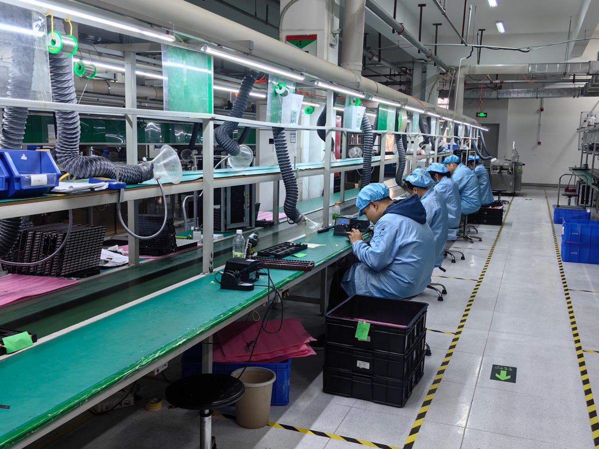 Assembly technicians working on an electronics production line