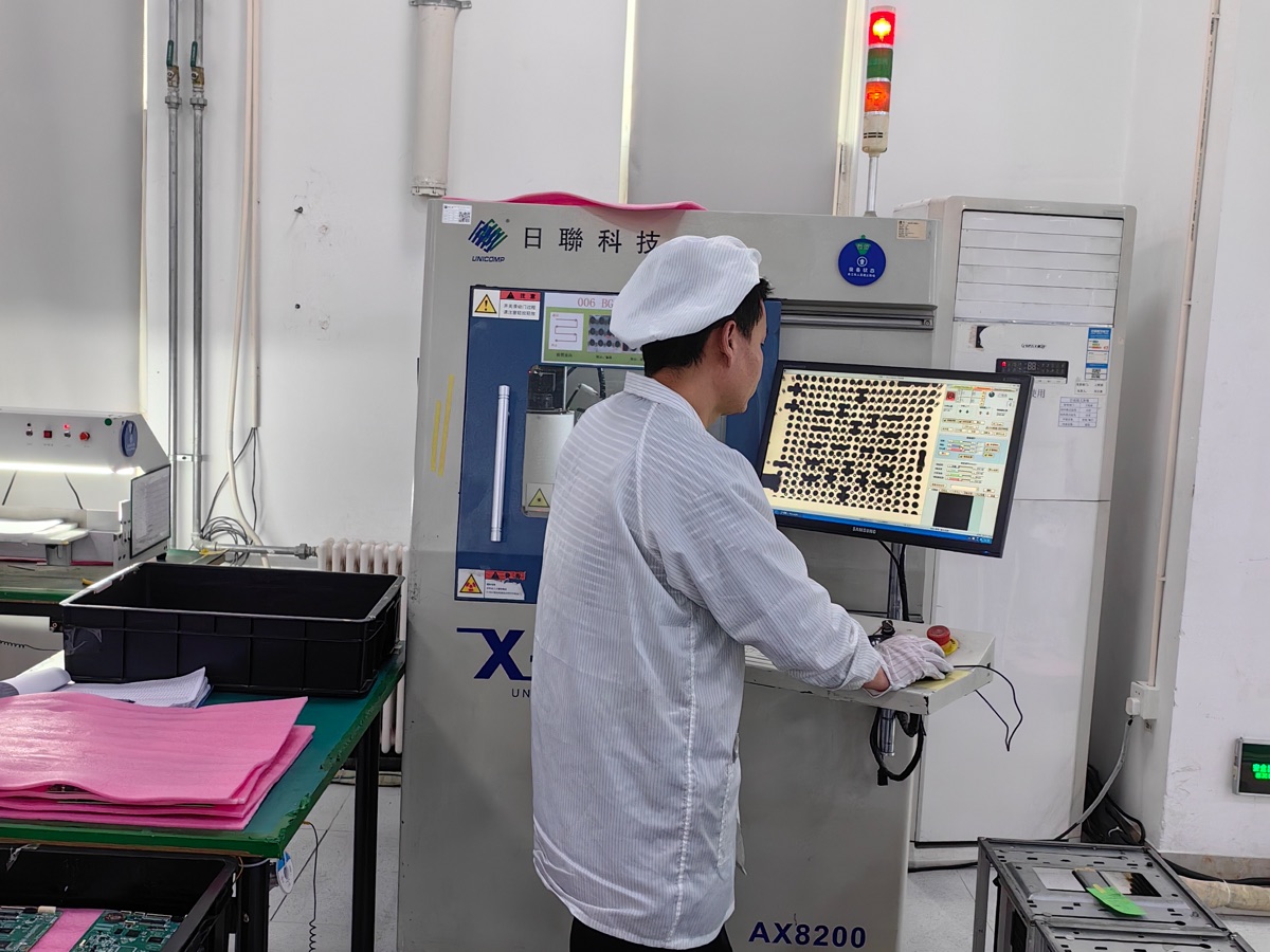 Factory technician operating an electronics test station